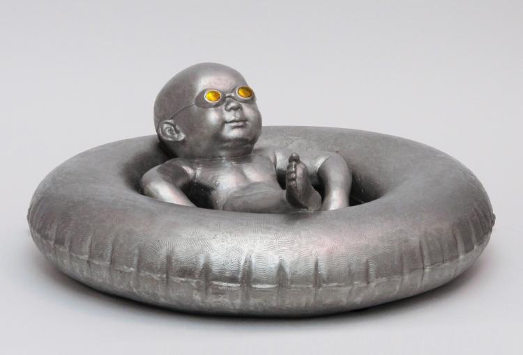 buoyant pool baby sculpture from above 