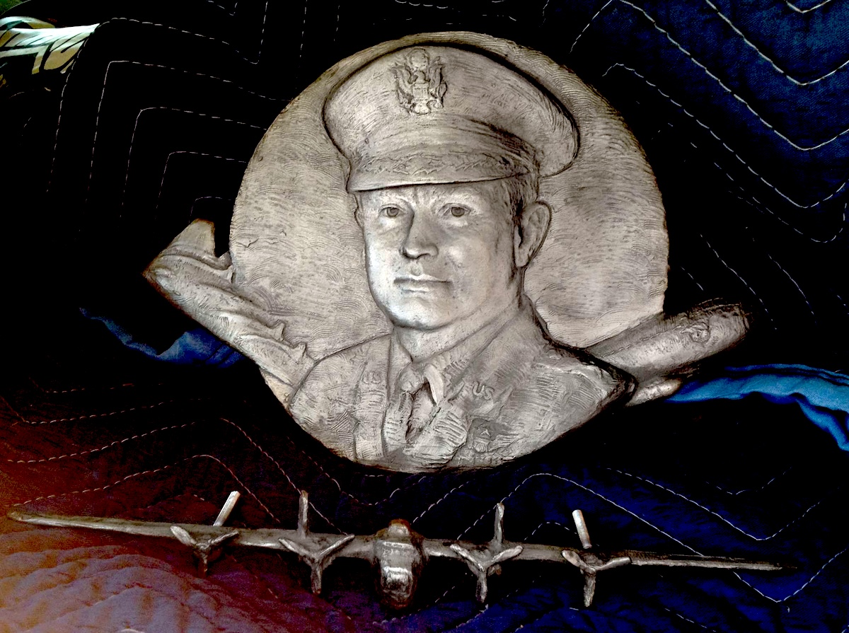 Detail of stainless steel bas-relief sculpt of Cardenas with vairous aircraft he flew.
