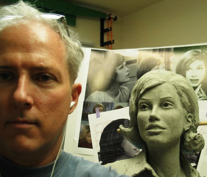 Mary Tyler Moore clay bust in progress with reference photos and artist Richard Becker
