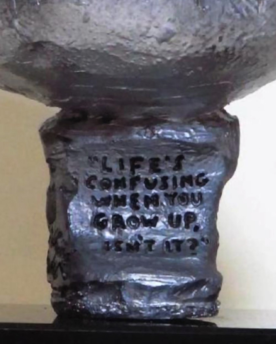 Engraved quote from Stewie Griffin on sculpture base reading “Life